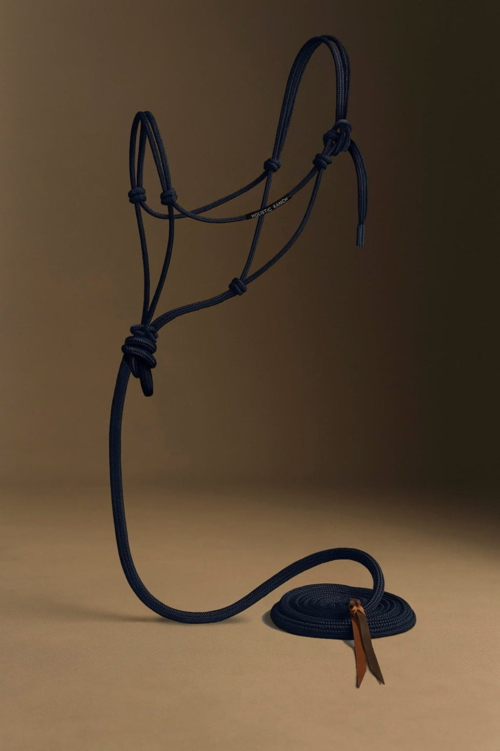 Navy blue horse rope halter with a brown leather buckle on a beige background