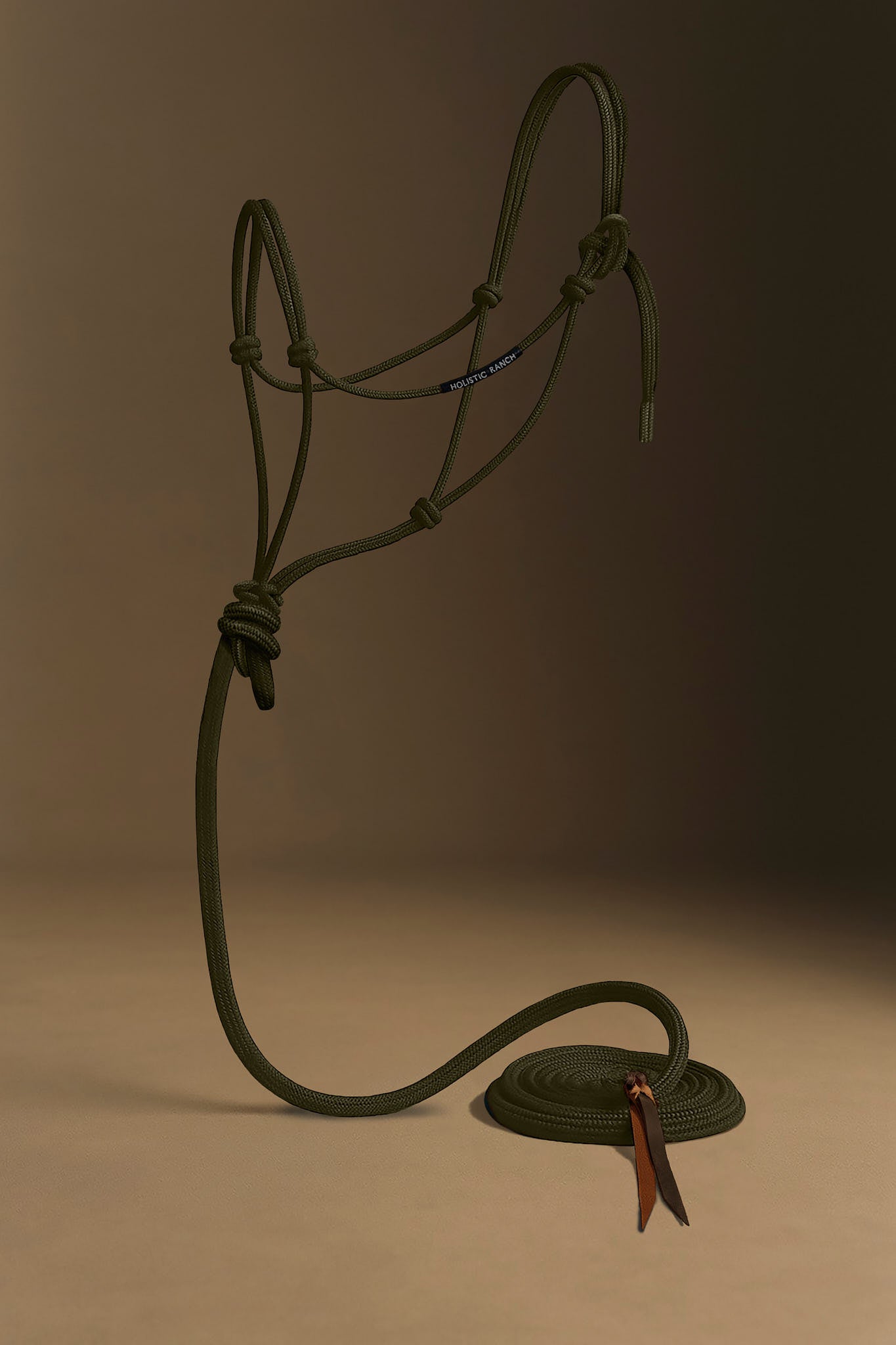 Green horse rope halter on a brown background.
