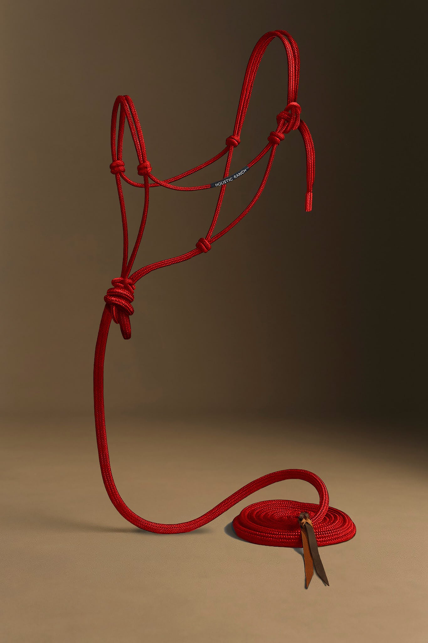 Red horse rope halter and lead rope on a brown background